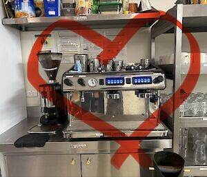 Photo of a coffee machine with a red love heart drawn around the machine.
