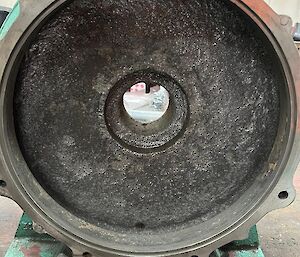 A large, round, clean metal lid sits on its side