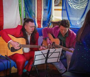 Two expeditioners with guitars ready to play some tunes.