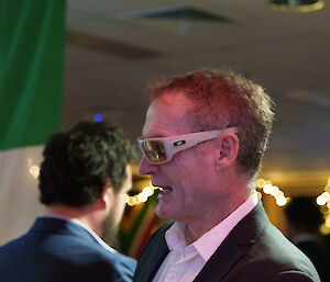 An expeditioner in the bar area, wearing sunglasses.