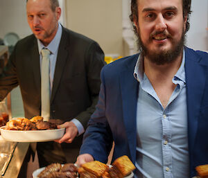 Expeditioners carrying food dishes from Kitchen - to be placed on the dinner table upstairs