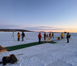A number of expeditioners putting the finishing touches to the swimming hole, including props and decorations