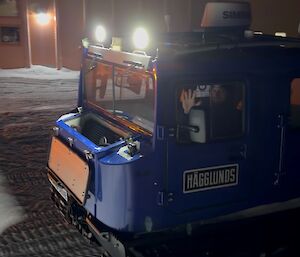 A blue snow tractor