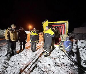 A group of hi vis wearing men in the dark