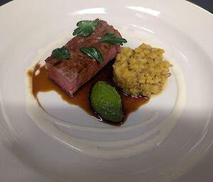 A white plate with fancy food on it.