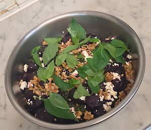A beetroot and green leave salad with walnuts and fetta