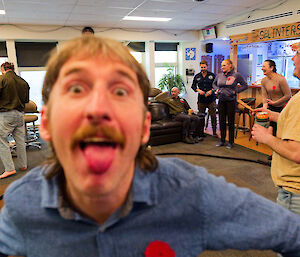 A man poking his tongue out to the camera