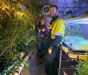 A smiling man and woman standing in the hydroponics shed