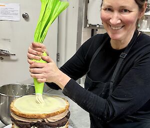 The station's chef applying the finishing touches to a multi-layered birthday cake