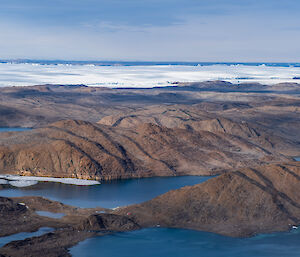 A landscape of rocky hills amongst blue water