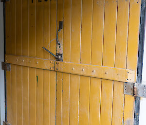 a yellow door that has the word plumbers written on it