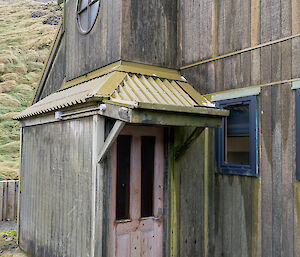 exterior of a faded pink door