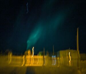 A blurry picture with aurora slightly visible in the sky
