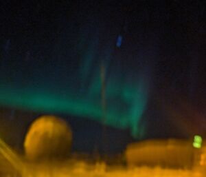 A blurry picture with aurora slightly visible in the sky