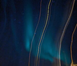 A blurry picture with aurora slightly visible in the sky