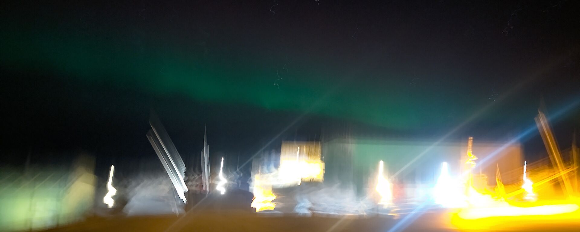 A blurry picture with aurora slightly visible in the sky