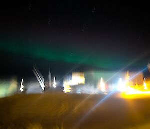 A blurry picture with aurora slightly visible in the sky