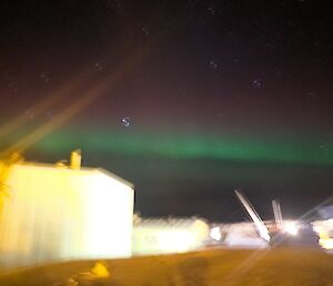 A blurry picture with aurora slightly visible in the sky