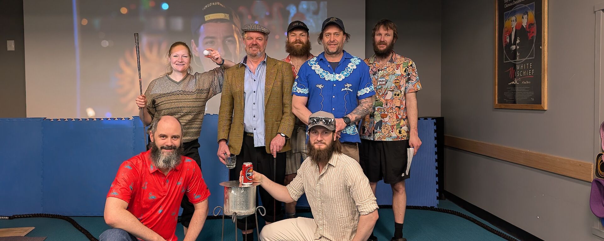 seven expeditioners inside wearing golf clothing
