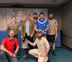 seven expeditioners inside wearing golf clothing