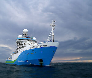 Blue and white ship at sea
