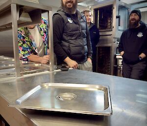 The Bain-marie lid almost stopped (spinning) on the kitchen top bench, with expeditioners looking on