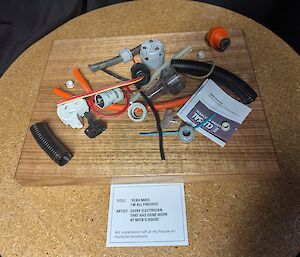 A collection of elecgtrical components siton a wooden board