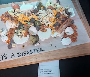 A collection of kitchen scraps are collected on a wooden board