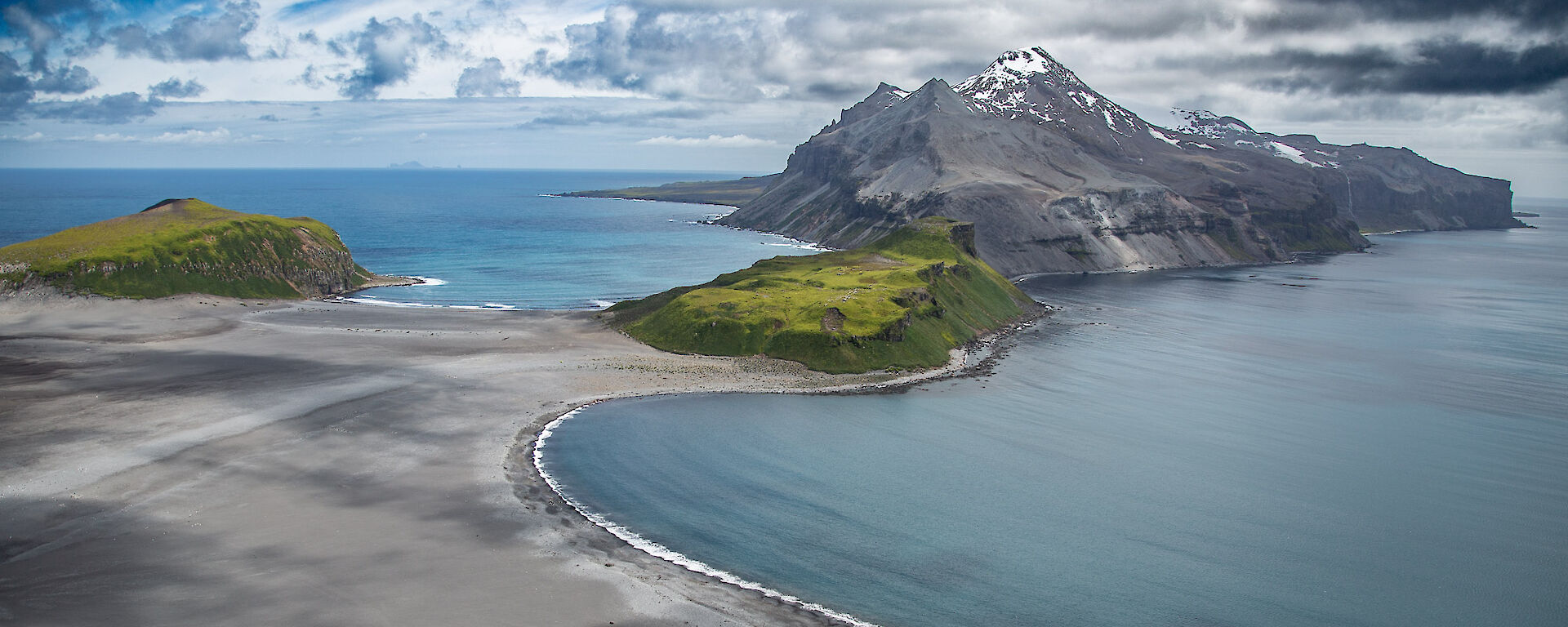 Aerial view of a mountainous island which some green patches