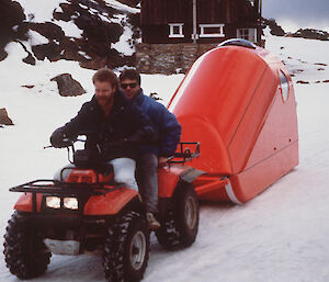 a historical picture of a quad bike towing a cocoon-like enclosed sled