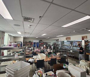 The mess hall is covered in an array of buckets, crockery, and cleaning utensils.