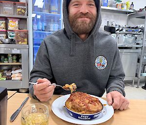 An expeditioner tucks into a hearty meal