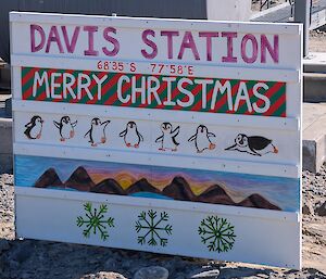 A large wooden sign wishing Merry Christmas from Davis Station