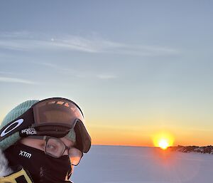 Picture of expeditioner outside while the sun is setting, with glasses fogged up