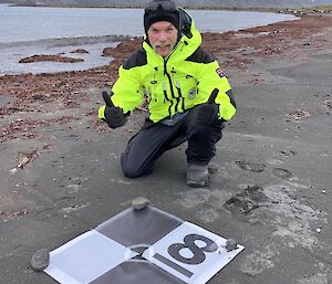 Author Cam Bennett takes a photo opportunity while assisting AAD surveyor Natalie Williams on Heard Island in late 2025