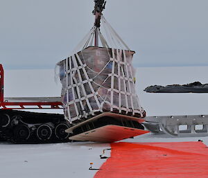 A large piece of cargo right next to a big orange square
