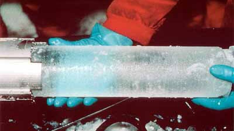 Gloved hands holding ice core