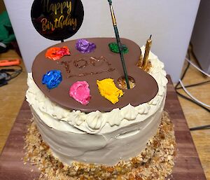 A picture of a birthday carrot cake with toffee caramel crumbs