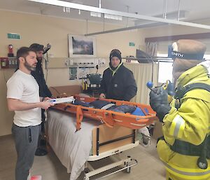 Station Doctor and Lay Surgical Assistants prpeare equipment in a medical room