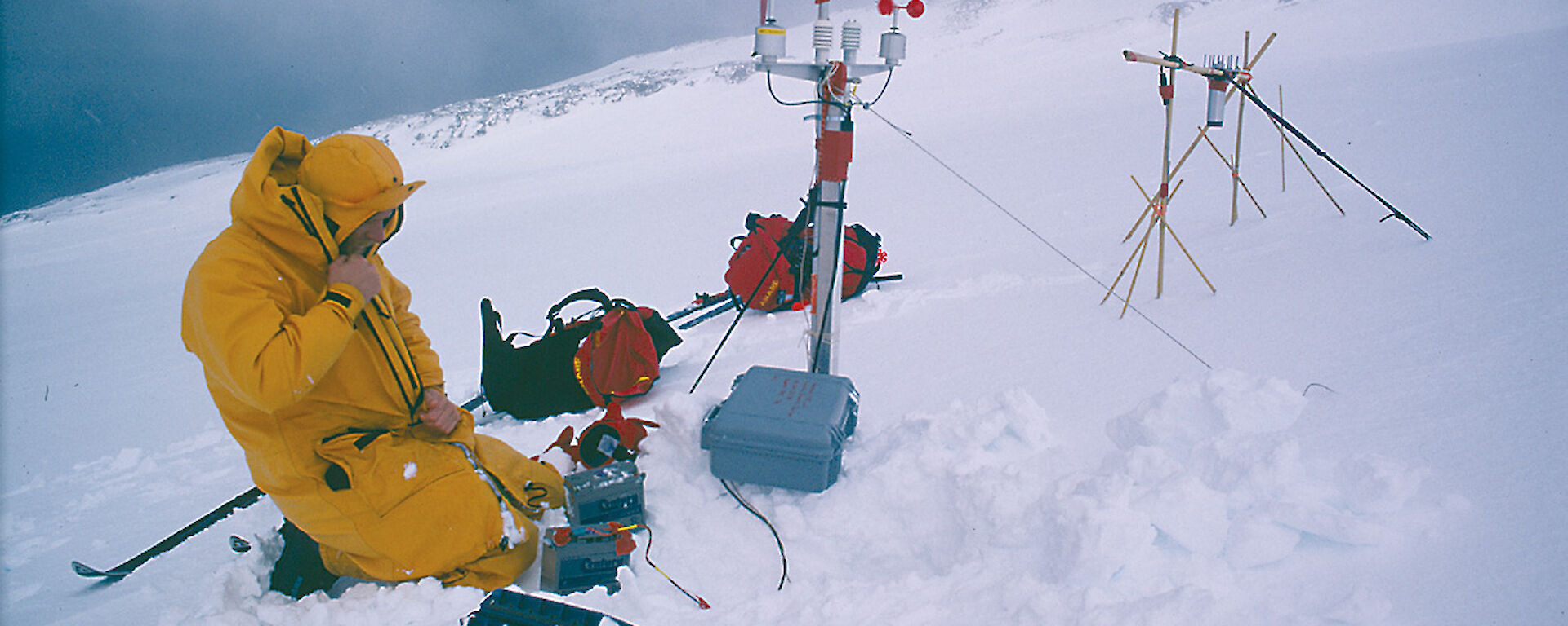 Expeditioner setting up climate data collection instruments