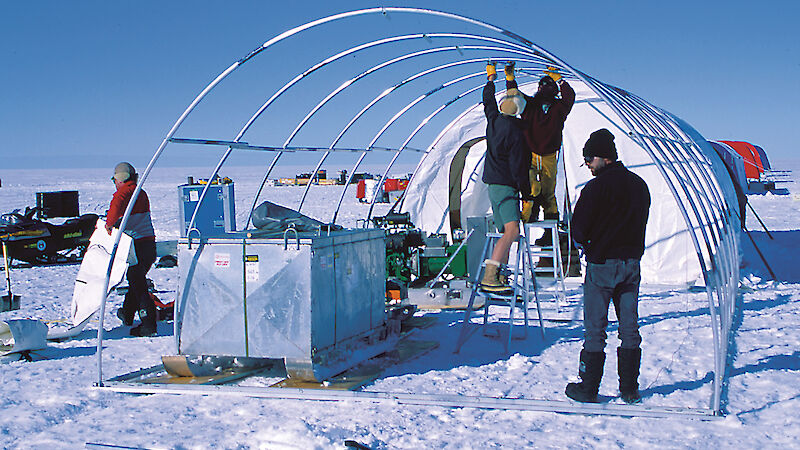 Expeditioners assemble a plant and equipment shelter for the AMISOR hot water drill