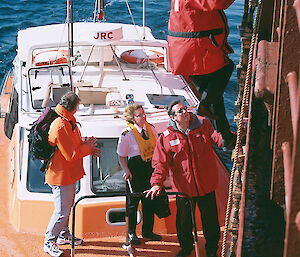 Assistant Director for Operations Branch, Kim Pitt (on ladder), and Director Tony Press, board Polar Bird in the Derwent River to greet returning Antarctic expeditioners