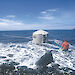 A tank hut is towed through the surf by rubber boat to Aurora Australis