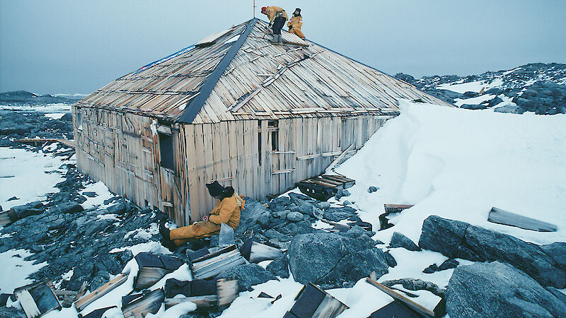 Specialists examine the roof and cladding of Mawson’s Hut