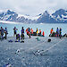 A group of private expeditioners, with their small vessels safely anchored, gets ready for a trek