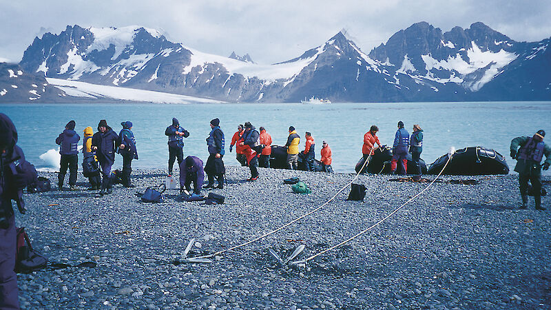 A group of private expeditioners, with their small vessels safely anchored, gets ready for a trek