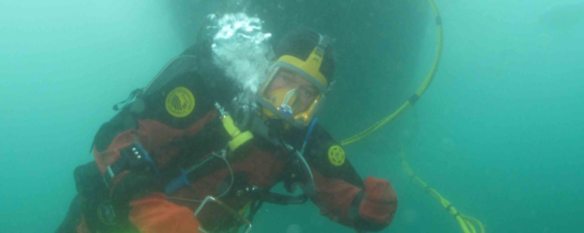 Diver ascending with a bag of samples