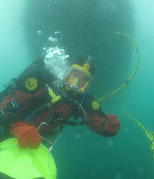 Diver ascending with a bag of samples
