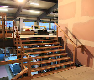 Inside the new living quarters at Davis — image shows a smalls staircase, unfinished walls.