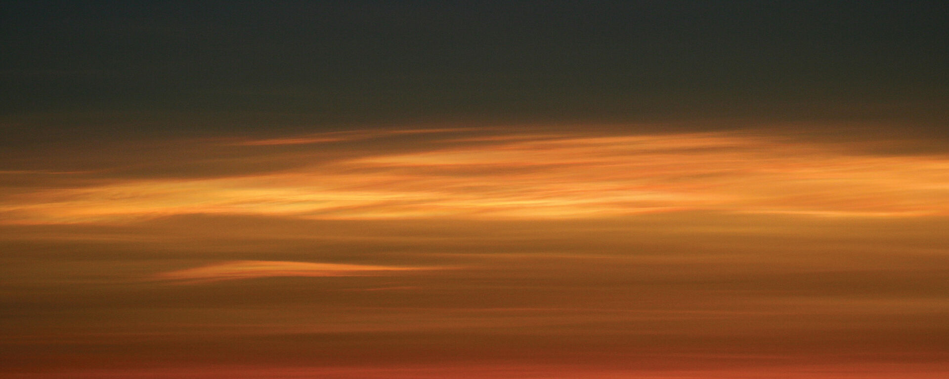 Stratospheric clouds, illuminated by the sun during twilight
